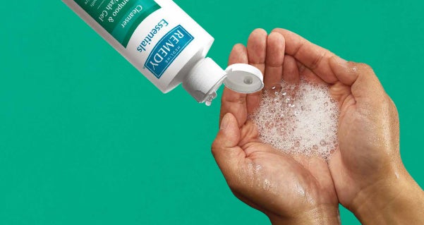 cleansing Hands with foam cleanser and bottle of foam cleanser.