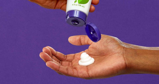 moisturizing Hand with moisturizer being poured and tube of moisturizer.