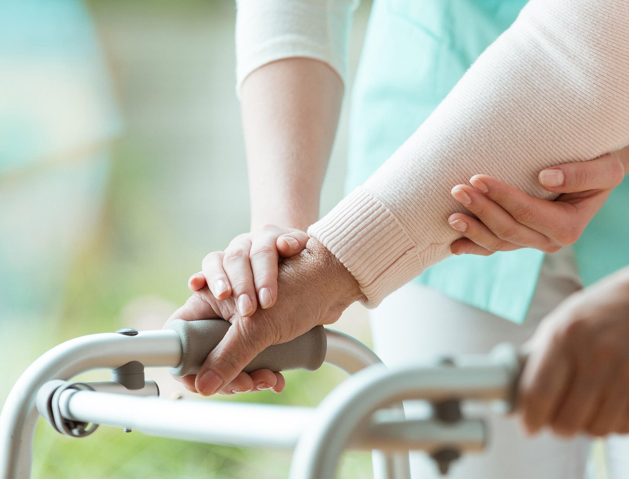 nurse assisting a patient using a walker Nurse assisting a patient using a walker.