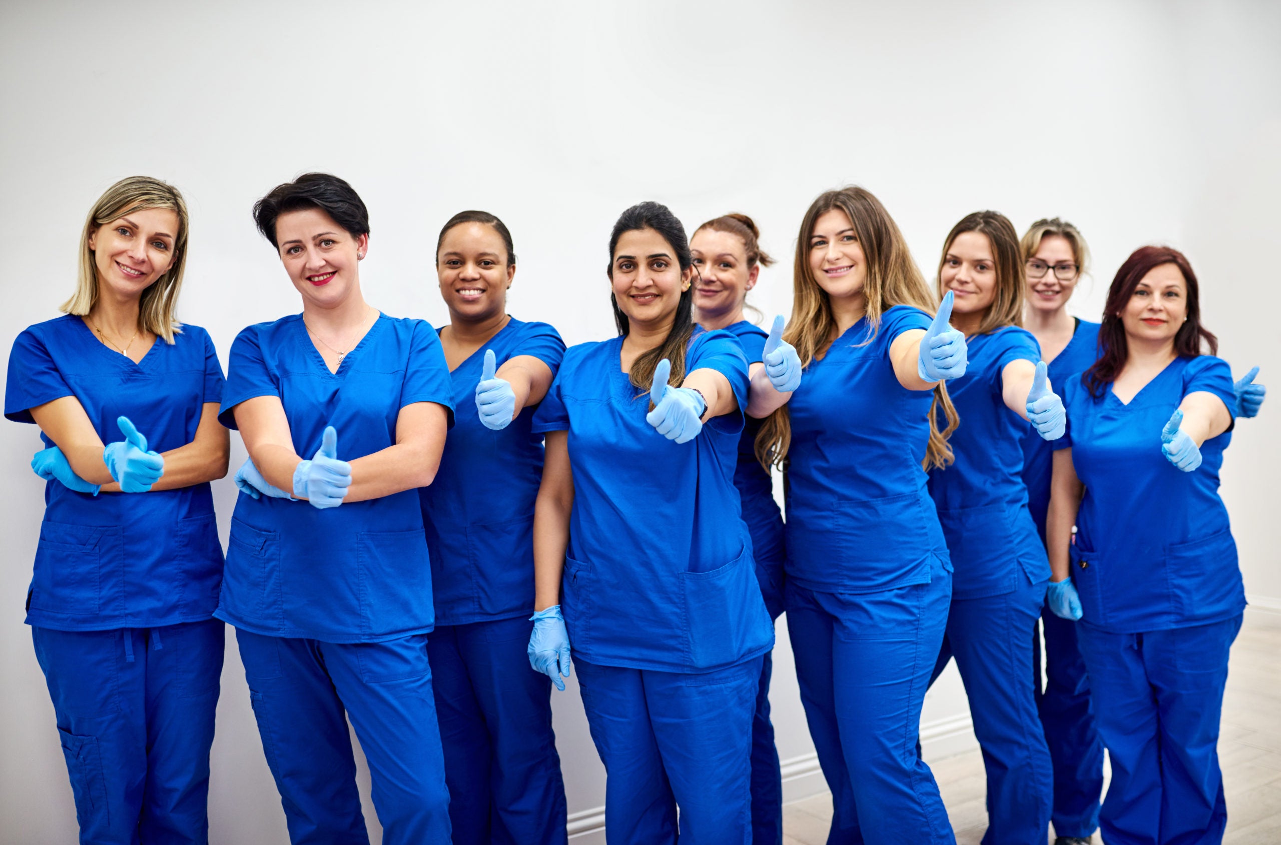 Line of nurse giving thumbs up