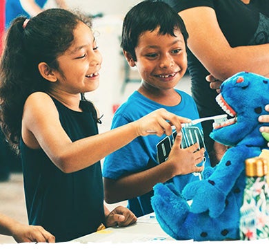 Honduran children brush a stuffed animal’s teeth. Honduran children brush a stuffed animal's teeth.