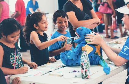 Honduran children brush a stuffed animal’s teeth. Honduran children brush a stuffed animal's teeth.