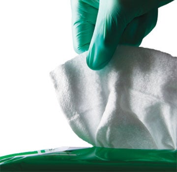 ReadyCleanse Catheter Gloved caregiver's hands taking out wipe from container