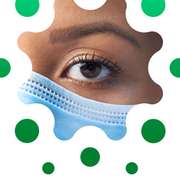 Close-up of female caregiver’s eye and the top edge of a face mask, cropped in distinctive circular shape. Close-up of female caregiver's eye and the top edge of a face mask, cropped in distinctive circular shape.