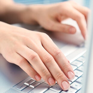 hands-laptop Hands typing on a keyboard