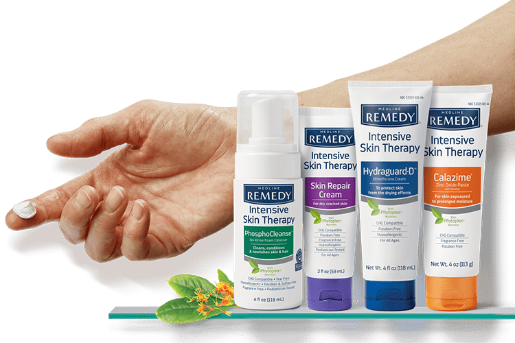 sh-ist-main-bnr-hand-img-1-min Outstretched arm and hand with cream on forefinger in back of grouping of Medline Remedy Intensive Skin Therapy products