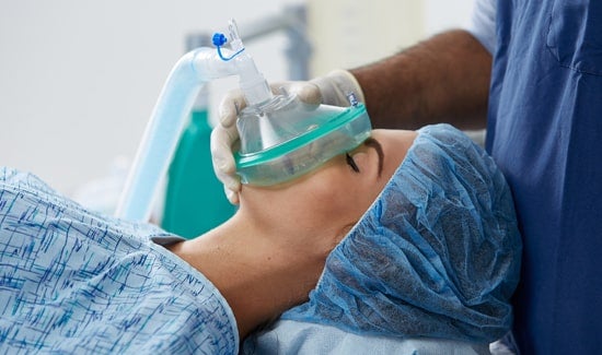 General-Anesthesia 1-min Doctor with gloved hand placing anesthesia mask over patient's face