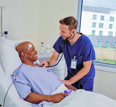 STK-Patient-and-Nurse Nurse providing bedside care and reassurance to patient