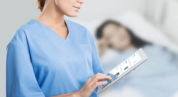 Clinician with stethoscope around her neck, viewing handheld computer device Clinician with stethoscope around her neck, viewing handheld computer device