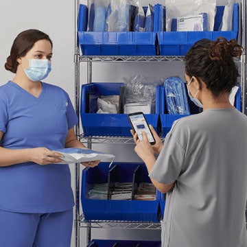 efficient_communication Two hospital employees taking inventory.