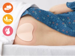 Protect-sacrum Patient in hospital gown lying on side with foam dressing on sacrum; insets of orange friction icon, yellow shear icon and pink moisture icon