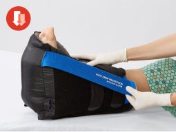 elevate-heels Clinician adjusting heel boot on patient foot; inset of red pressure icon