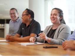 build-career-healthcare Three men and one woman sitting at a conference table