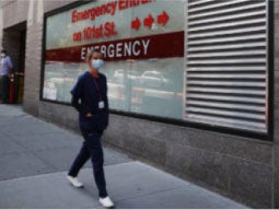 nurse-walking-outside-hospital-in-NYC nurse walking outside hospital in NYC